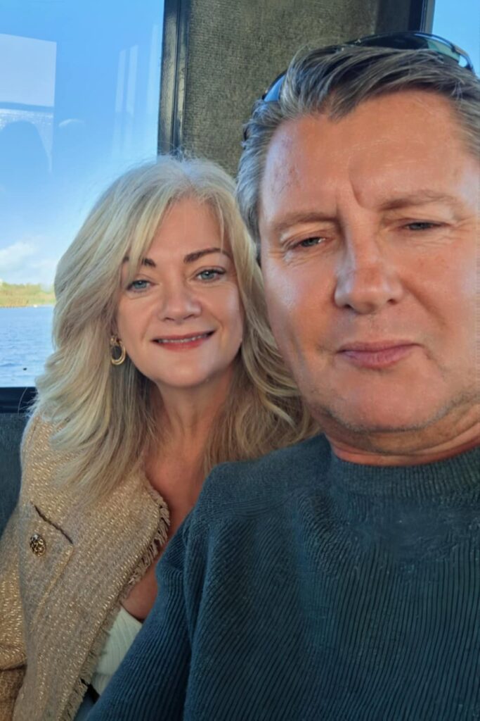 Sian (An attractive blonde lady) and her partner Perry (A gentleman wearing a blue jumper with salt and pepper hair) in Barcelona Baby